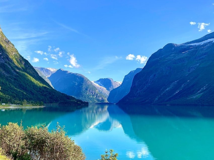Norsk fjord med turkost vatten och höga berg
