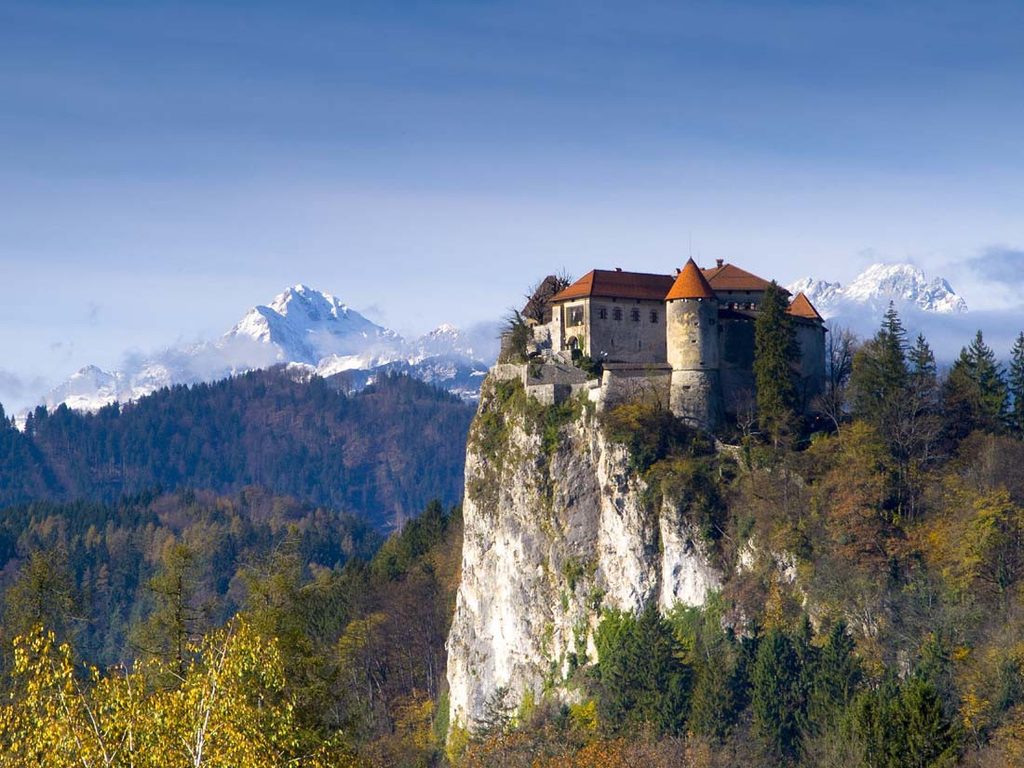 Bleds slott i Slovenien med Julianalperna i bakgrunden